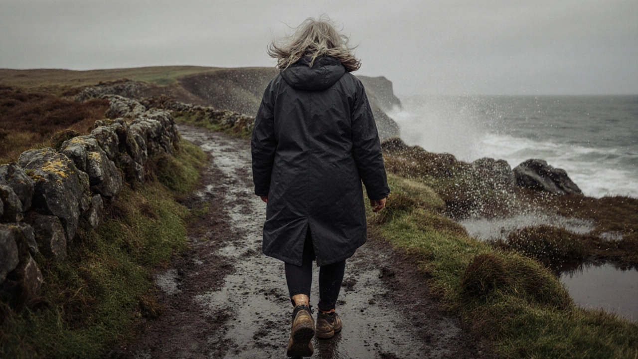 An elderly woman walking along a rugged coastal path in Donegal wearing sturdy waterproof walking shoes.