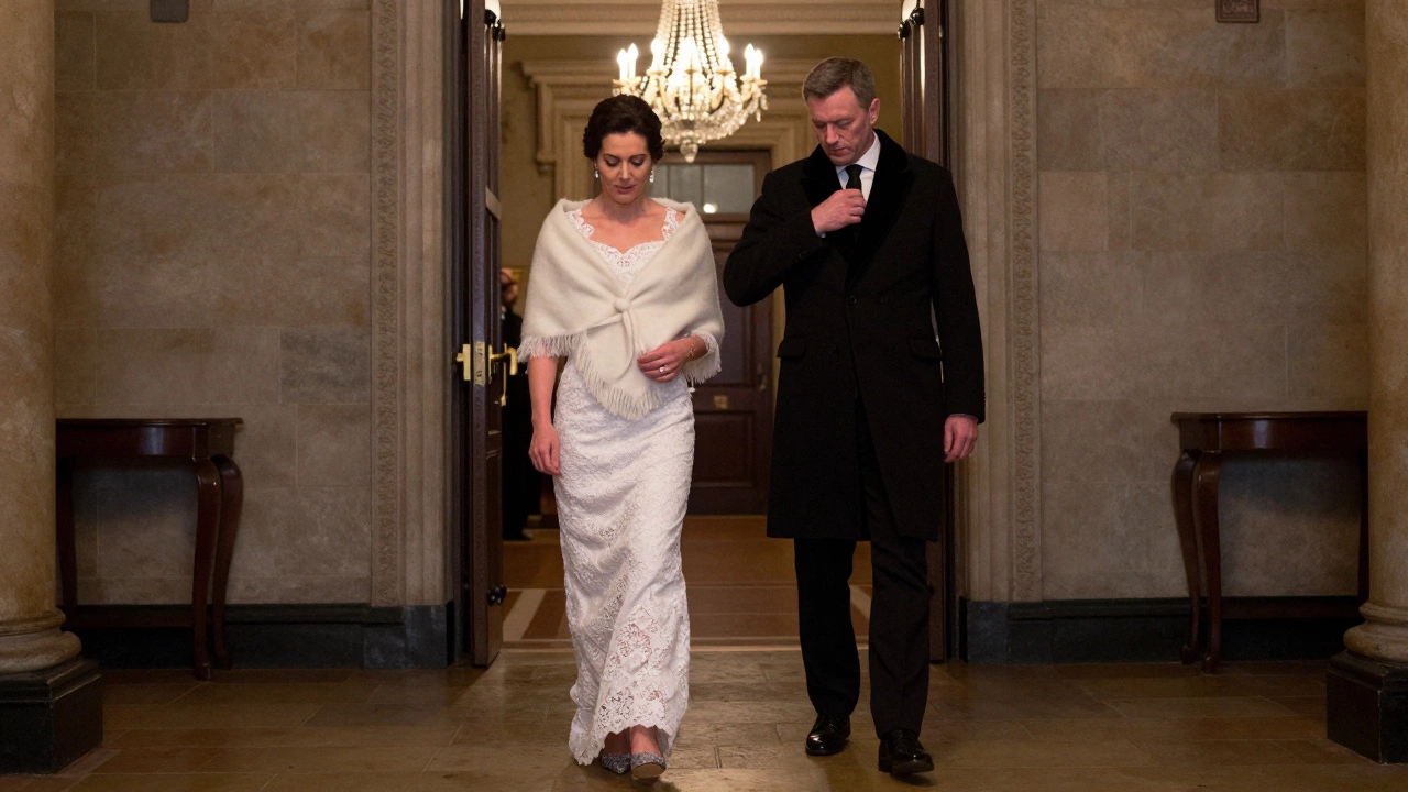 Woman in lace gown and cashmere wrap stepping carefully on stone floor at a formal event.