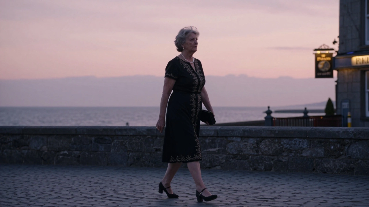 An older woman walking at sunset in Galway wearing a black embroidered knee-length dress.