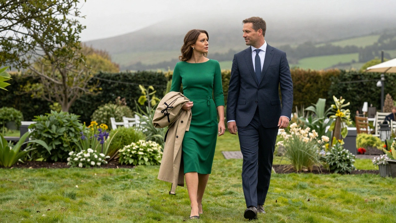 Couple in smart attire walking through misty Irish garden with trench coats